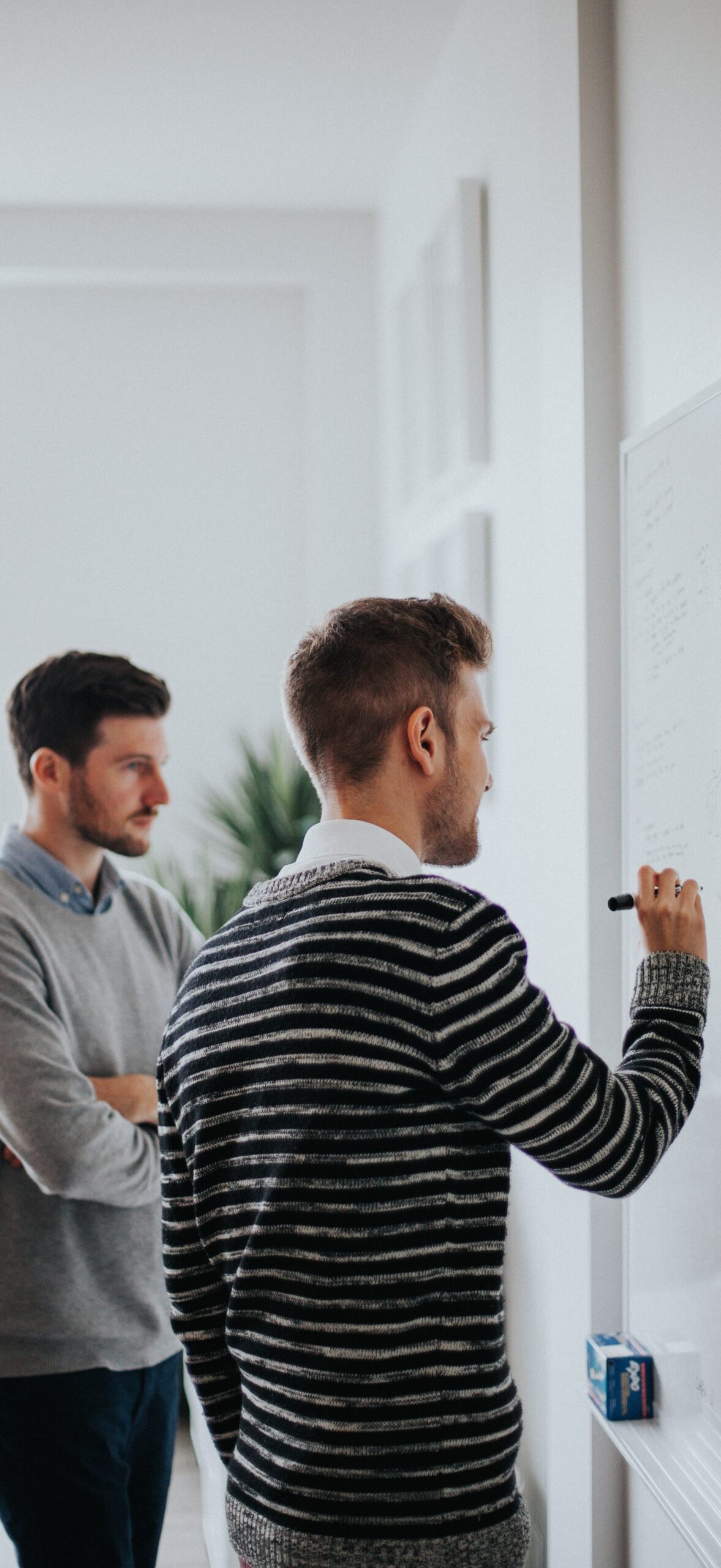 men working at whiteboard