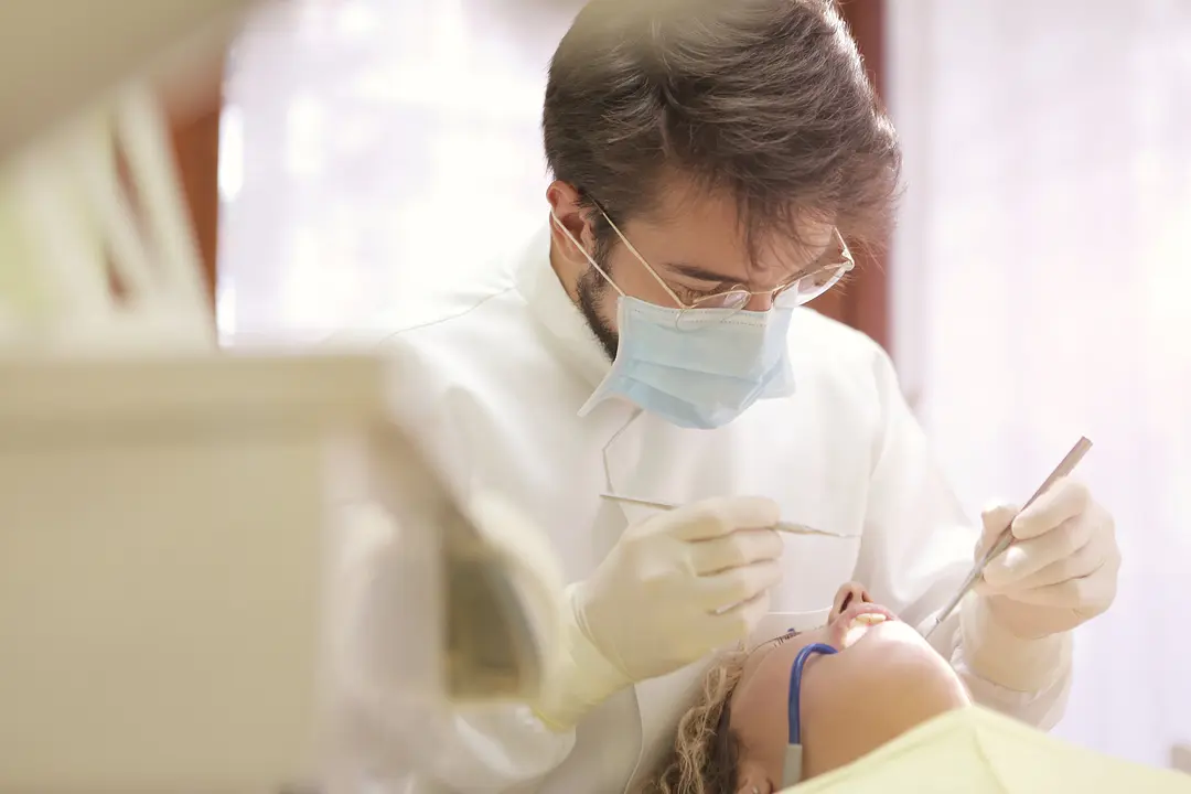 Dentist examining patient's teeth