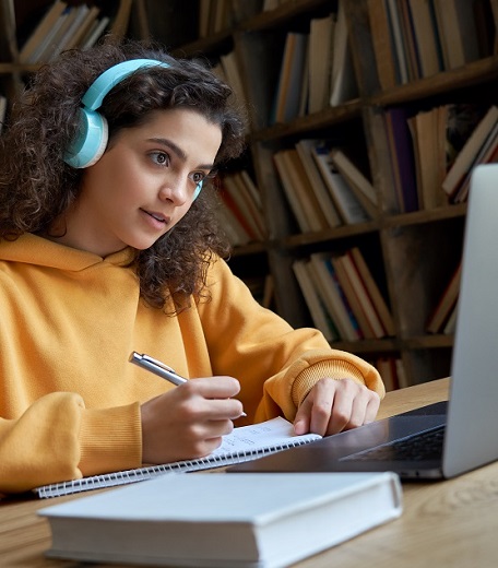 A student taking notes during an Online Engineering internship.