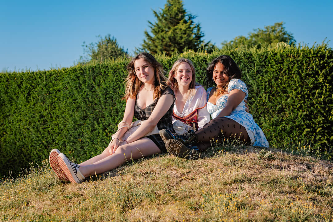 Three Oxford Scholastica students sitting outside and smiling