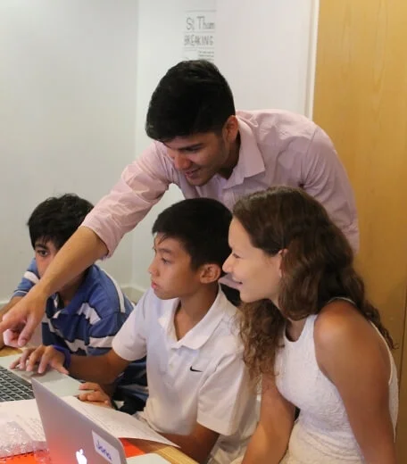 A tutor explaining what needs to be done to a group of students at Oxford Scholastica summer school.