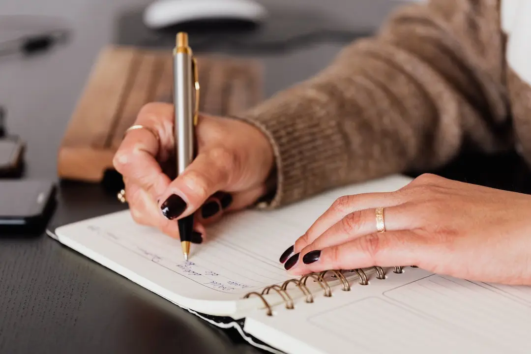 A student planning their goals in a notebook.