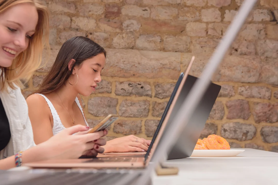 Two students working on their laptops