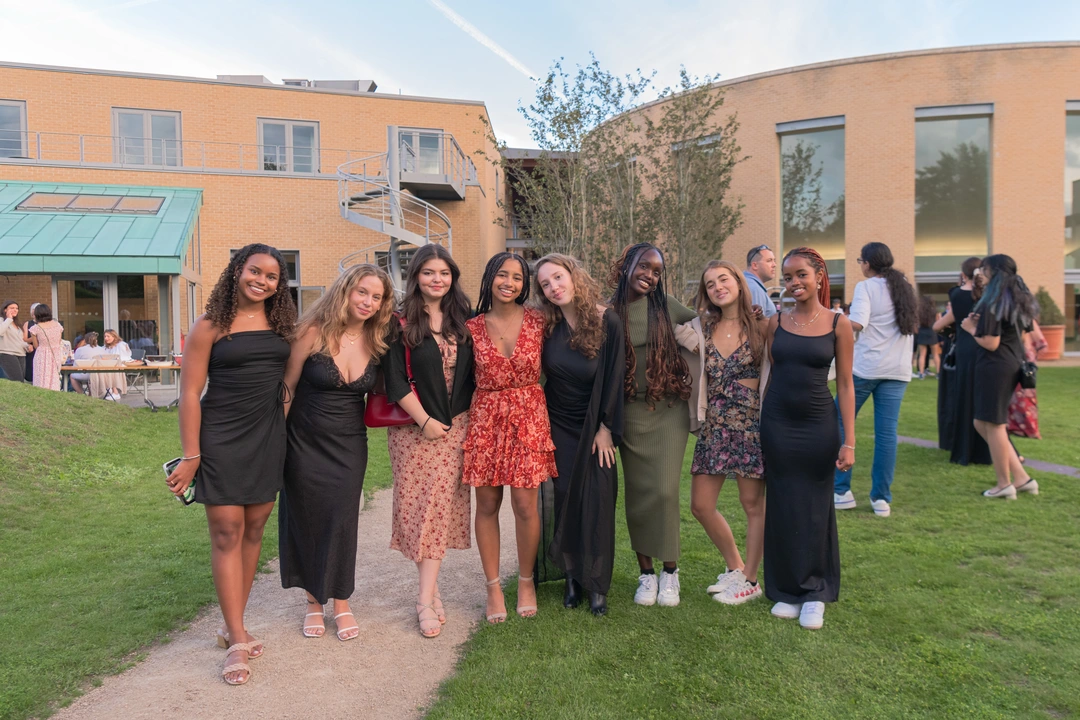 Group of students smiling outside